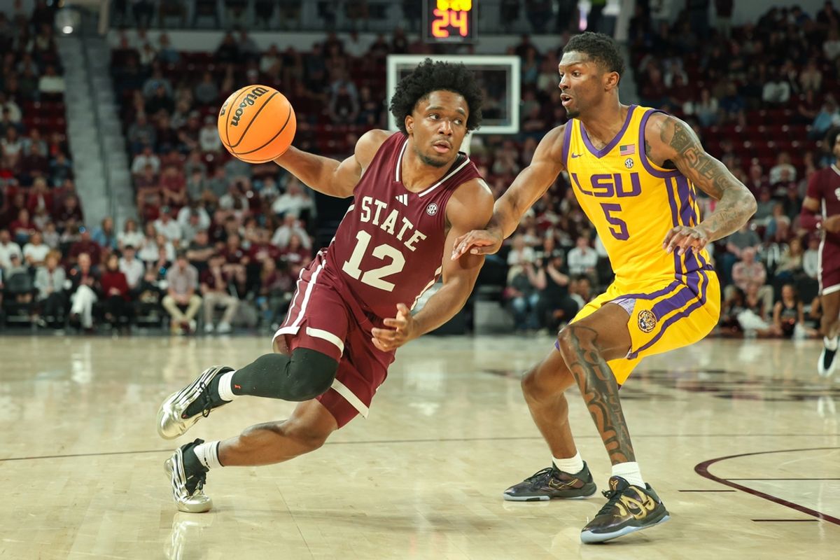 Mar 1, 2025; Starkville, Mississippi, USA; Mississippi State Bulldogs guard Josh Hubbard (12) drives to the basket against LSU Tigers guard Cam Carter (5) during the second half at Humphrey Coliseum. Mandatory Credit: Wesley Hale-Imagn Images