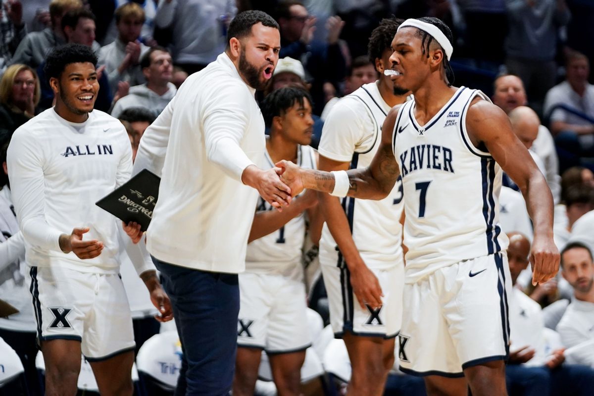 Xavier Musketeers guard Ryan Conwell (7) is embraced by his team after hitting a layup in the second half of a NCAA men’s basketball game between the Xavier Musketeers and Creighton Bluejays, Saturday, March 1, 2025, at Cintas Center in Cincinnati. Musketeers won 83-61.