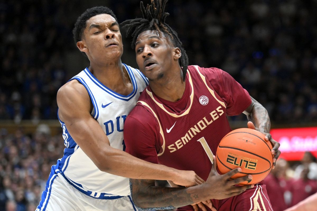 Mar 1, 2025; Durham, North Carolina, USA;  Florida State Seminoles guard Jamir Watkins (1) breaks around Duke Blue Devils guard Caleb Foster (1) during the first half at Cameron Indoor Stadium. Mandatory Credit: Zachary Taft-Imagn Images