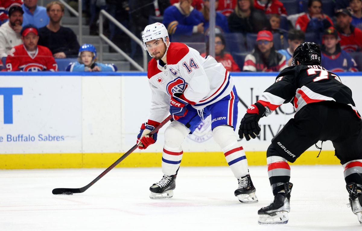 Mar 1, 2025; Buffalo, New York, USA;  Montreal Canadiens center Nick Suzuki (14) looks to make a pass as Buffalo Sabres defenseman Jacob Bryson (78) defends during the first period at KeyBank Center. Mandatory Credit: Timothy T. Ludwig-Imagn Images