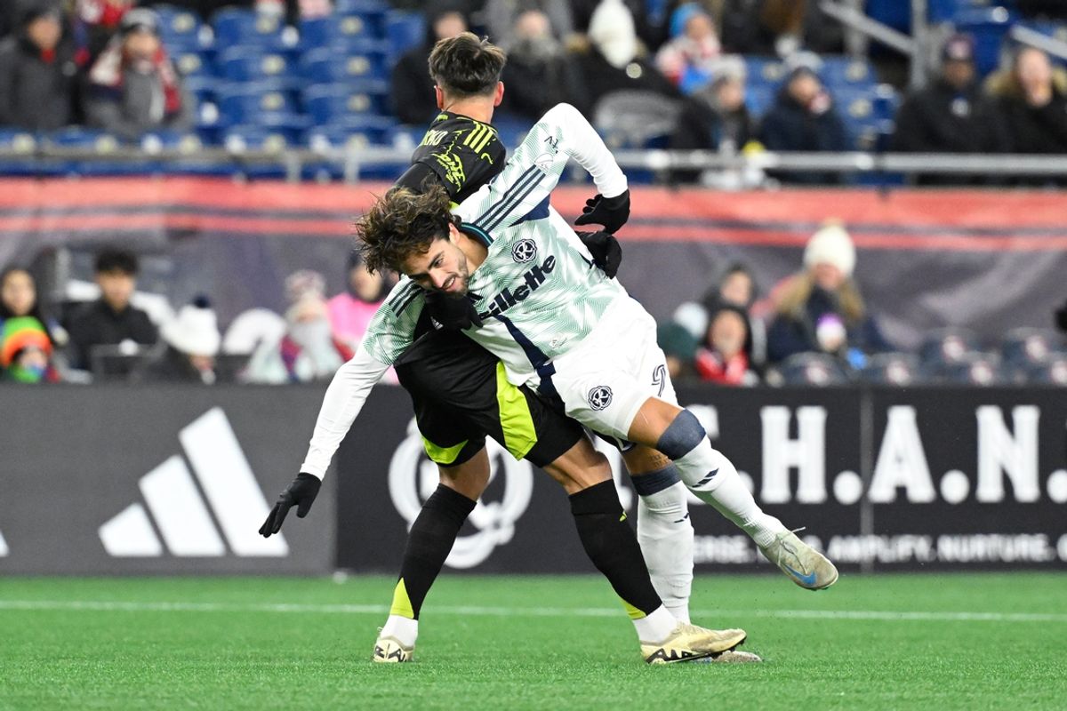 Mar 1, 2025; Foxborough, Massachusetts, USA; Columbus Crew defender Yevhen Cheberko (21) pulls down New England Revolution forward Leonardo Campana (9) during the first half at Gillette Stadium. Mandatory Credit: Eric Canha-Imagn Images