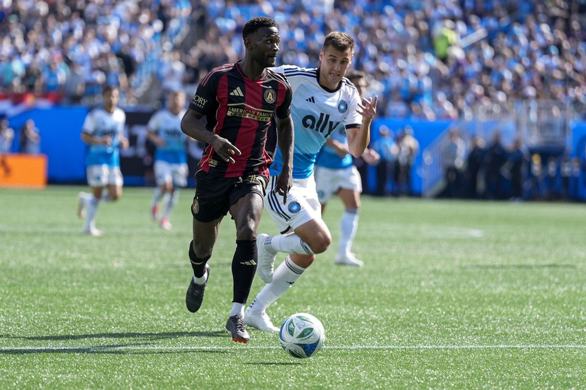 Mar 1, 2025; Charlotte, North Carolina, USA; Atlanta United forward Emmanuel Latte Lath (19) brings the ball up field defended by Charlotte FC midfielder Andrew Privett (4) during the first half at Bank of America Stadium. Mandatory Credit: Jim Dedmon-Imagn Images