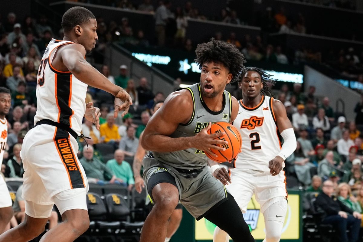 Mar 1, 2025; Waco, Texas, USA;  Baylor Bears forward Norchad Omier (15) controls the ball as Oklahoma State Cowboys forward Abou Ousmane (33) defends during the first half at Paul and Alejandra Foster Pavilion. Mandatory Credit: Chris Jones-Imagn Images