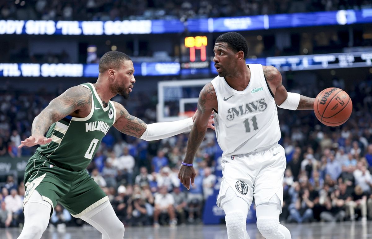 Mar 1, 2025; Dallas, Texas, USA;  Dallas Mavericks guard Kyrie Irving (11) controls the ball as Milwaukee Bucks guard Damian Lillard (0) defends during the first half at American Airlines Center. Mandatory Credit: Kevin Jairaj-Imagn Images
