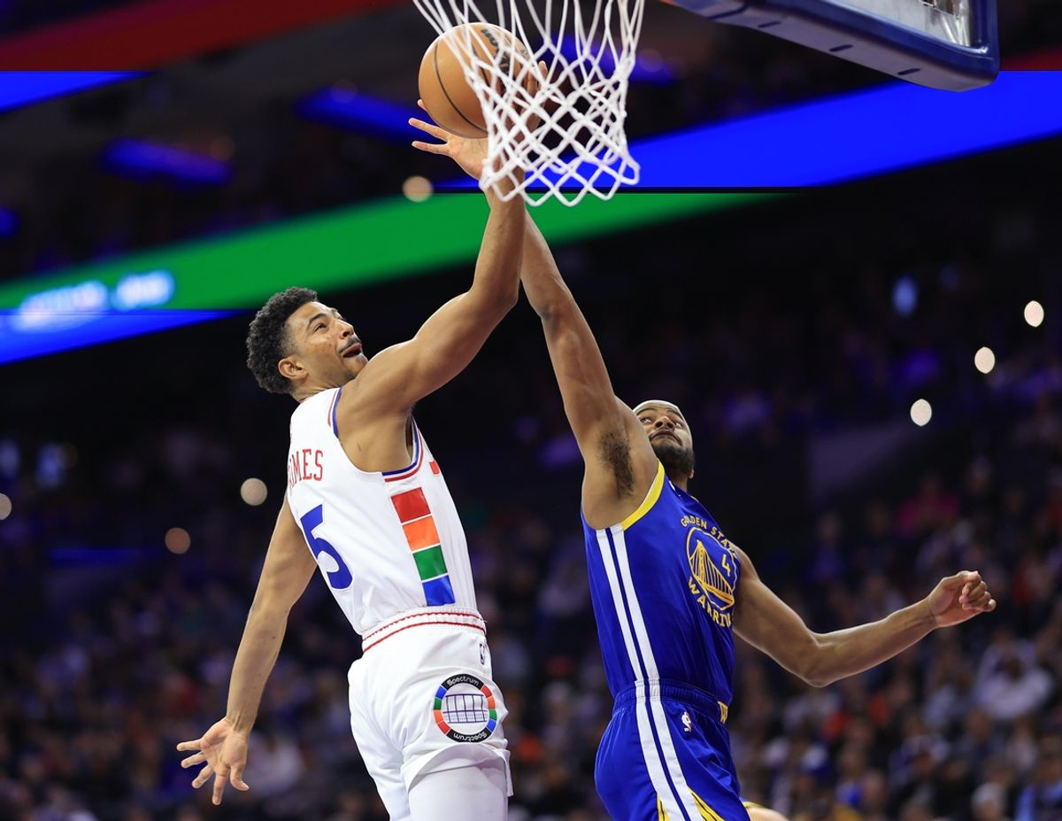 Mar 1, 2025; Philadelphia, Pennsylvania, USA; Philadelphia 76ers guard Quentin Grimes (5) scores past Golden State Warriors guard Moses Moody (4) during the first quarter at Wells Fargo Center. Mandatory Credit: Bill Streicher-Imagn Images