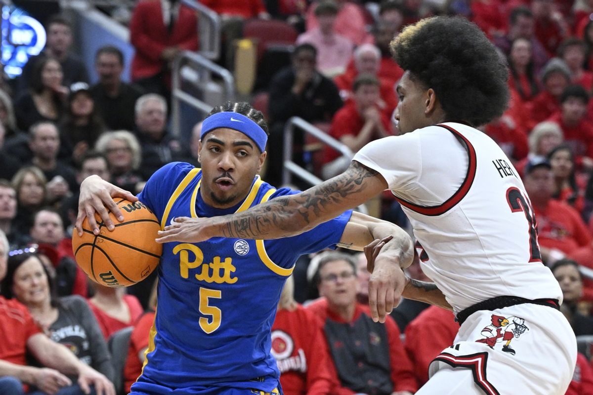 Mar 1, 2025; Louisville, Kentucky, USA;  Pittsburgh Panthers guard Ishmael Leggett (5) drives to the basket against Louisville Cardinals guard Chucky Hepburn (24) during the first half at KFC Yum! Center. Louisville defeated Pittsburgh 79-68. Mandatory Credit: Jamie Rhodes-Imagn Images