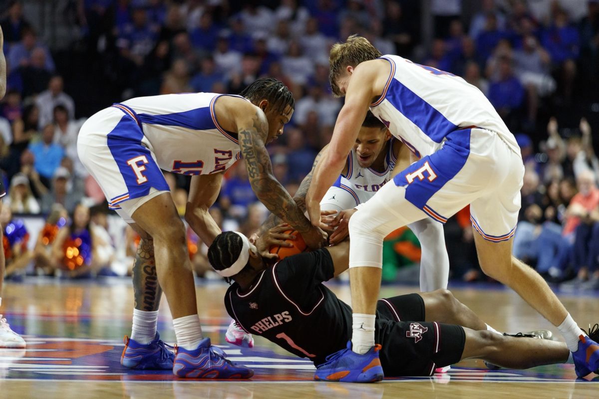 Mar 1, 2025; Gainesville, Florida, USA; Florida Gators guard Alijah Martin (15), guard Will Richard (5), forward Thomas Haugh (10) and Texas A&M Aggies guard Zhuric Phelps (1) wrestle for the ball during the first half at Exactech Arena at the Stephen C. O'Connell Center. Mandatory Credit: Morgan Tencza-Imagn Images