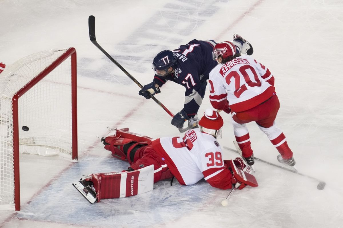 Mar 1, 2025; Columbus, Ohio, USA;  Columbus Blue Jackets right wing Justin Danforth (17) scores a goal against Detroit Red Wings goaltender Cam Talbot (39) and defenseman Albert Johansson (20) in the third period at Ohio Stadium. Mandatory Credit: Aaron Doster-Imagn Images