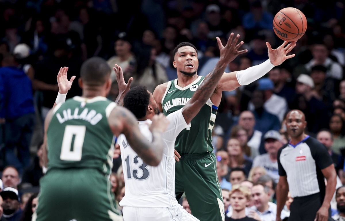 Mar 1, 2025; Dallas, Texas, USA; Milwaukee Bucks forward Giannis Antetokounmpo (34) passes to Milwaukee Bucks guard Damian Lillard (0) as Dallas Mavericks forward Naji Marshall (13) defends during the first half at American Airlines Center. Mandatory Credit: Kevin Jairaj-Imagn Images