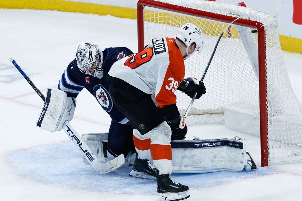 Mar 1, 2025; Winnipeg, Manitoba, CAN;  Philadelphia Flyers forward Matvei Michov (39) scores on Winnipeg Jets goalie Connor Hellebuyck (37) during the shootout at Canada Life Centre. Mandatory Credit: Terrence Lee-Imagn Images