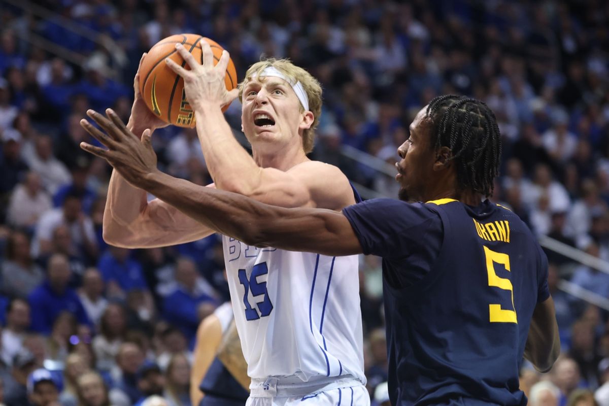 Mar 1, 2025; Provo, Utah, USA; Brigham Young Cougars guard Dawson Baker (25) goes to the basket against West Virginia Mountaineers guard Toby Okani (5) during the first half at Marriott Center. Mandatory Credit: Rob Gray-Imagn Images