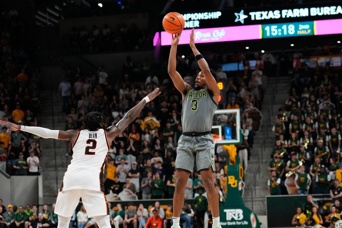 Mar 1, 2025; Waco, Texas, USA;  Baylor Bears guard Jeremy Roach (3) scores a three-point basket against Oklahoma State Cowboys guard Arturo Dean (2) during the second half at Paul and Alejandra Foster Pavilion. Mandatory Credit: Chris Jones-Imagn Images