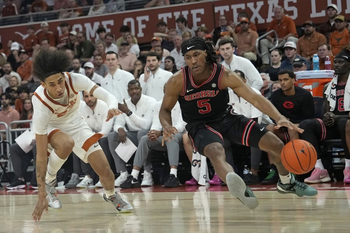 Mar 1, 2025; Austin, Texas, USA; Georgia Bulldogs guard Silas Demary Jr. (5) drives to the basket against Texas Longhorns forward Devon Pryor (22) during the second half at Moody Center. Mandatory Credit: Scott Wachter-Imagn Images