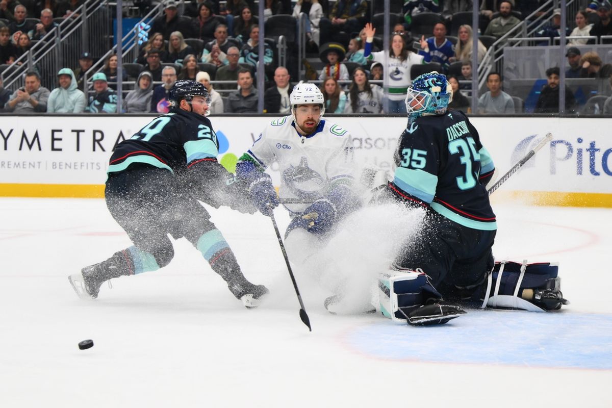 Mar 1, 2025; Seattle, Washington, USA; Seattle Kraken goaltender Joey Daccord (35) blocks a goal shot by Vancouver Canucks center Filip Chytil (72) during the second period at Climate Pledge Arena. Mandatory Credit: Steven Bisig-Imagn Images