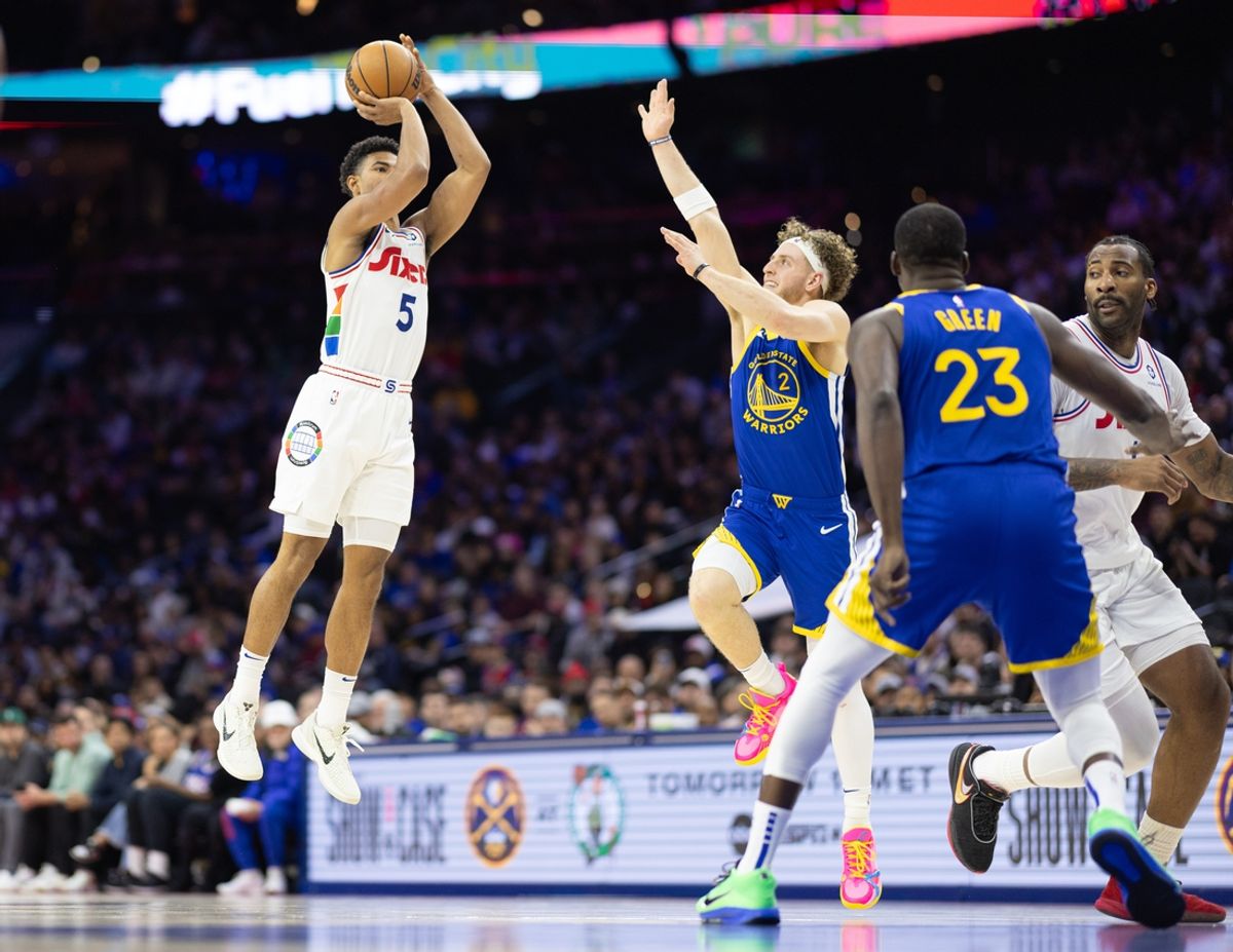 Mar 1, 2025; Philadelphia, Pennsylvania, USA; Philadelphia 76ers guard Quentin Grimes (5) scores past Golden State Warriors guard Brandin Podziemski (2) during the second quarter at Wells Fargo Center. Mandatory Credit: Bill Streicher-Imagn Images