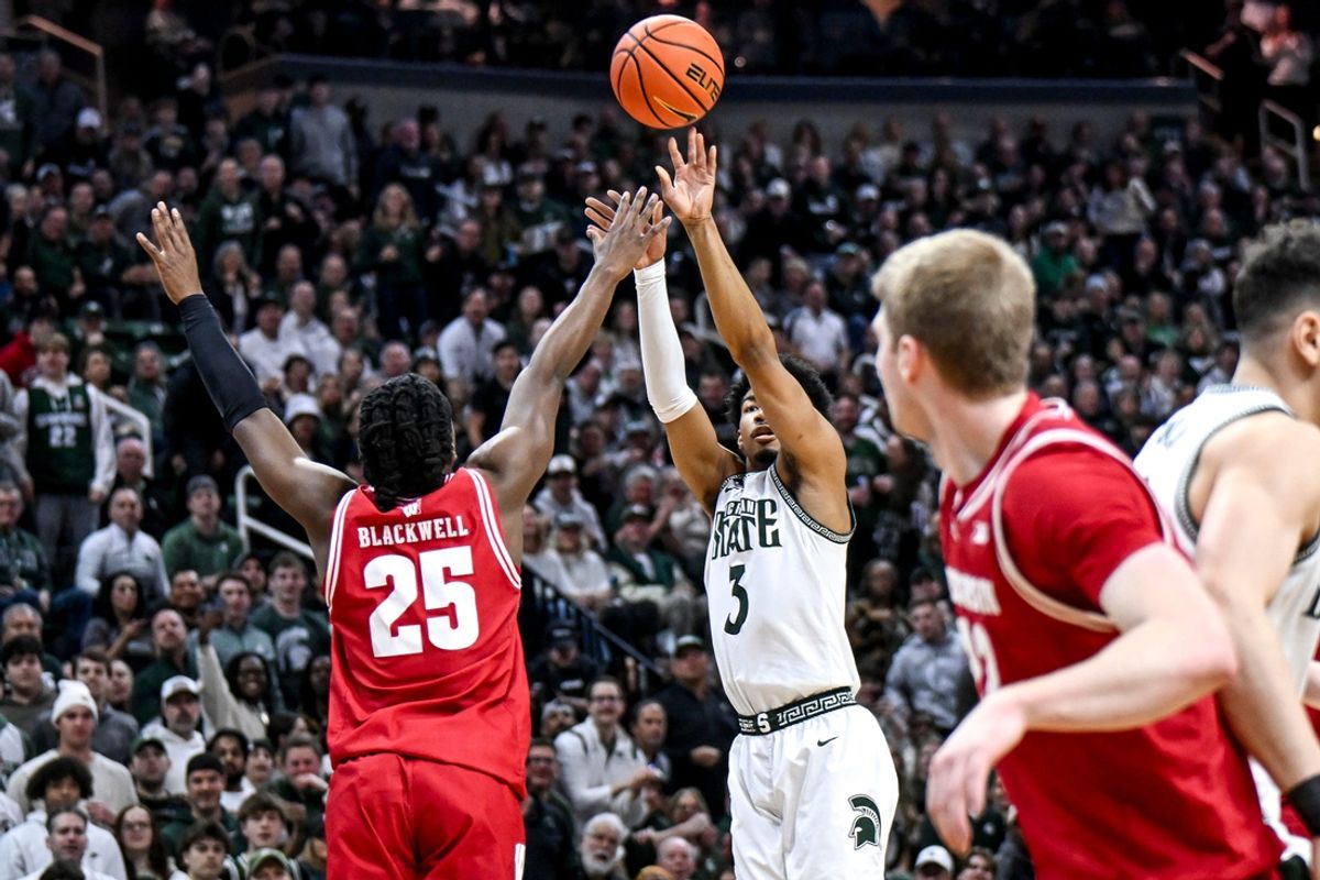 Michigan State's Jaden Akins, right, scores against Wisconsin's John Blackwell during the first half on Sunday, March 2, 2025, at the Breslin Center in East Lansing.