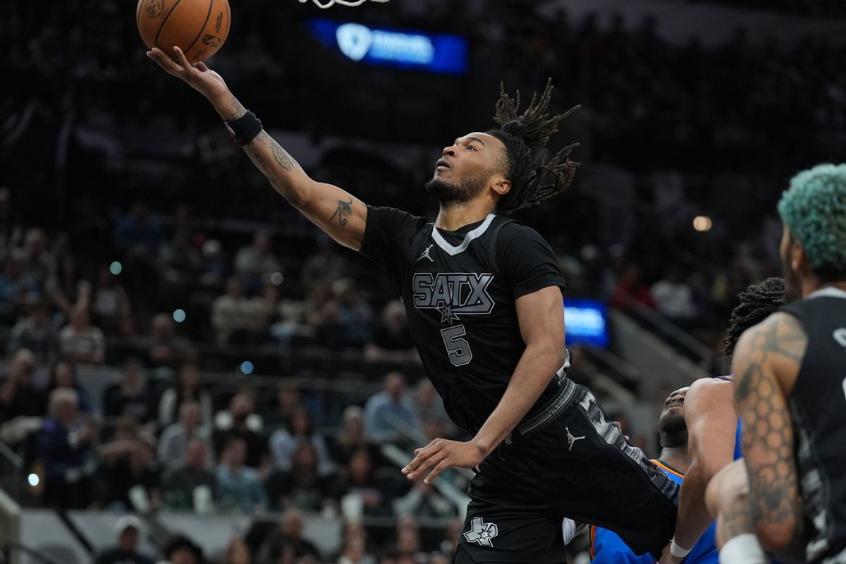 Mar 2, 2025; San Antonio, Texas, USA;  San Antonio Spurs guard Stephon Castle (5) lays the ball up in the first half against the Oklahoma City Thunder at Frost Bank Center. Mandatory Credit: Daniel Dunn-Imagn Images
