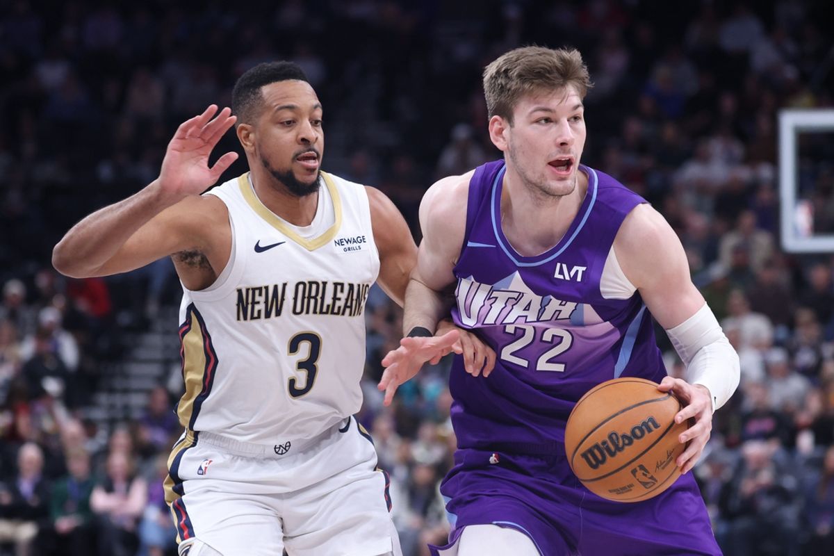 Mar 2, 2025; Salt Lake City, Utah, USA; Utah Jazz forward Kyle Filipowski (22) moves the ball against New Orleans Pelicans guard CJ McCollum (3) during the first half at Delta Center. Mandatory Credit: Rob Gray-Imagn Images