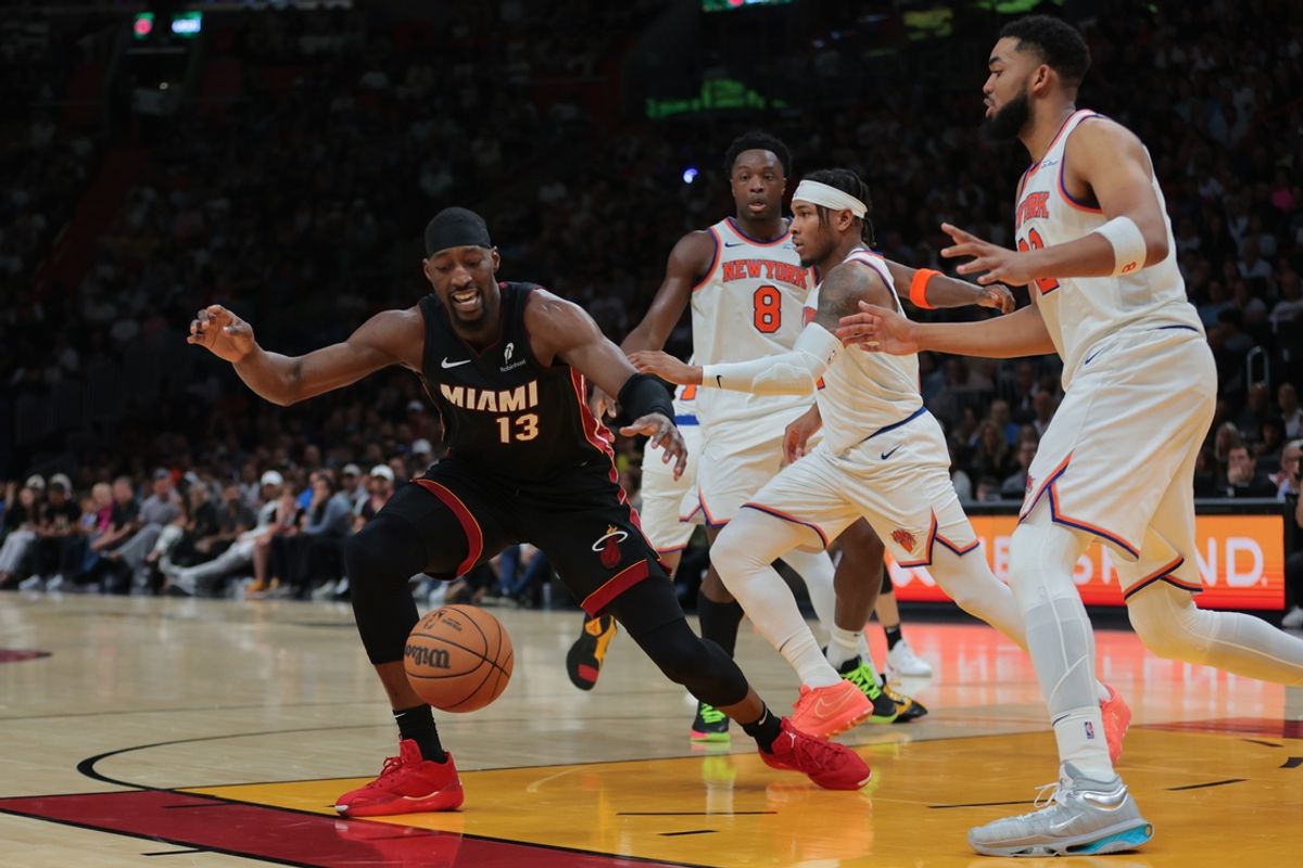 Mar 2, 2025; Miami, Florida, USA; Miami Heat center Bam Adebayo (13) reaches for the basketball against New York Knicks center Karl-Anthony Towns (32) during the fourth quarter at Kaseya Center. Mandatory Credit: Sam Navarro-Imagn Images