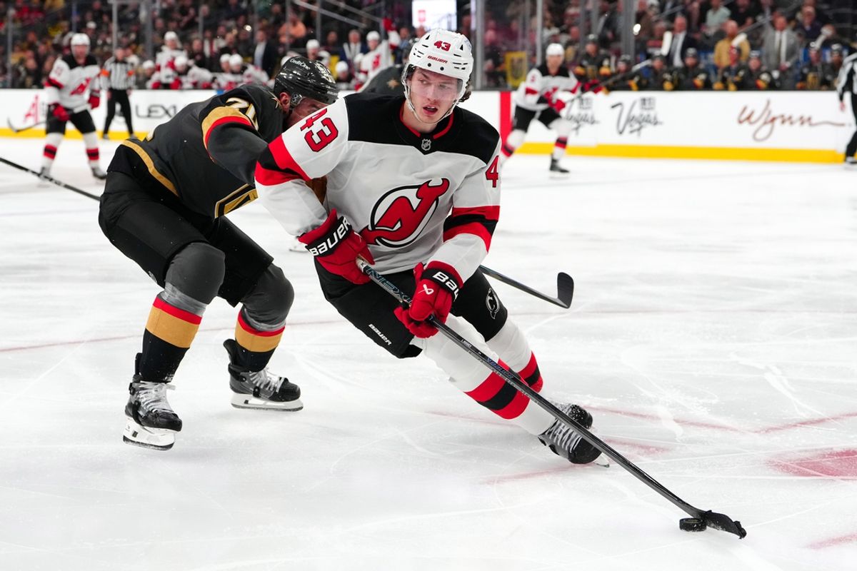 Mar 2, 2025; Las Vegas, Nevada, USA; New Jersey Devils defenseman Luke Hughes (43) skates the puck away from Vegas Golden Knights left wing Tanner Pearson (70) during the second period at T-Mobile Arena. Mandatory Credit: Stephen R. Sylvanie-Imagn Images