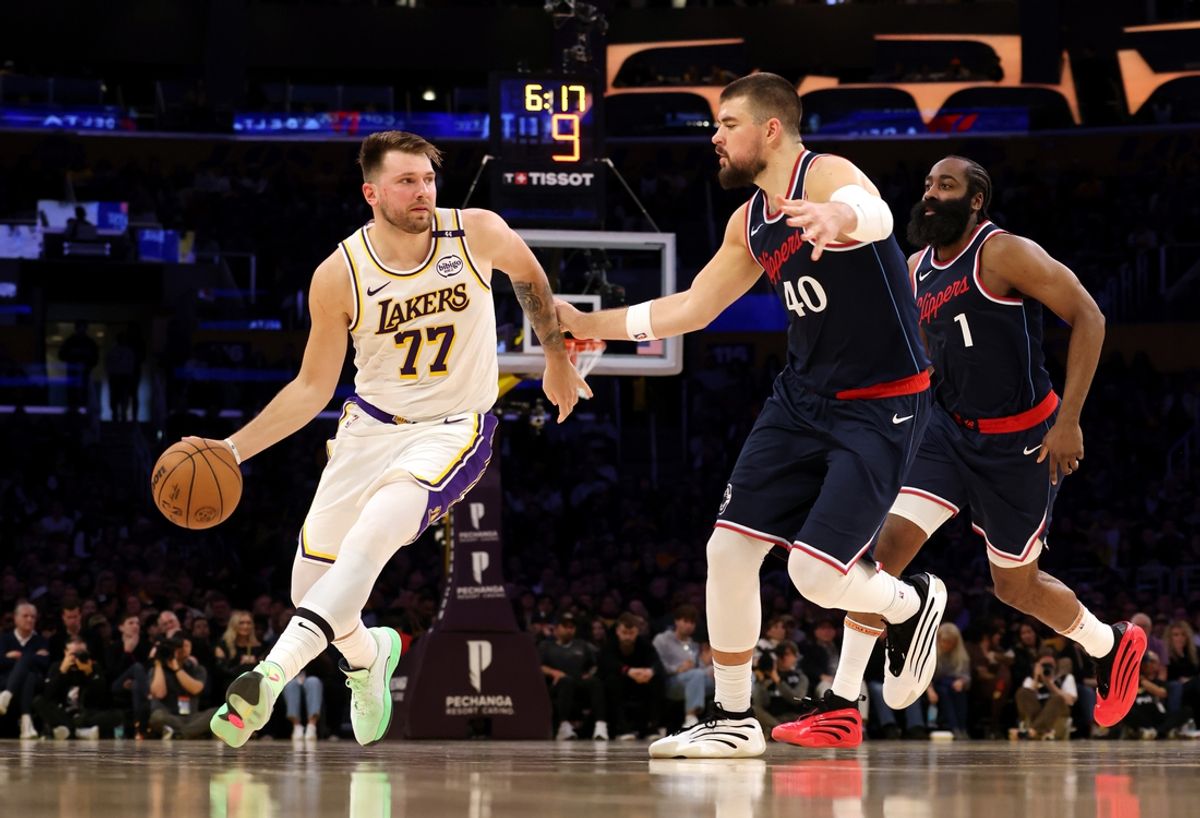 Mar 2, 2025; Los Angeles, California, USA; Los Angeles Lakers guard Luka Doncic (77) dribbles against LA Clippers center Ivica Zubac (40) and guard James Harden (1) during the second quarter at Crypto.com Arena. Mandatory Credit: Jason Parkhurst-Imagn Images