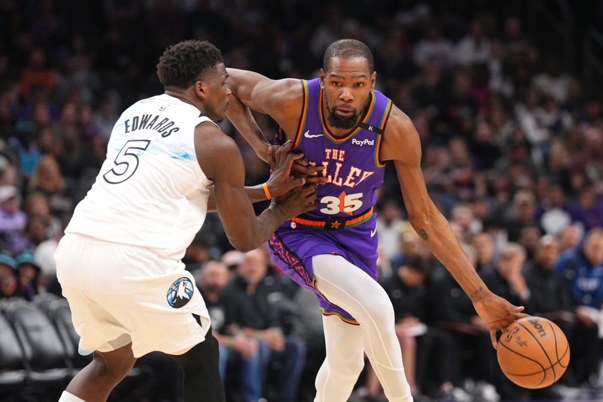Mar 2, 2025; Phoenix, Arizona, USA; Phoenix Suns forward Kevin Durant (35) dribbles against Minnesota Timberwolves guard Anthony Edwards (5) during the second half at Footprint Center. Mandatory Credit: Joe Camporeale-Imagn Images