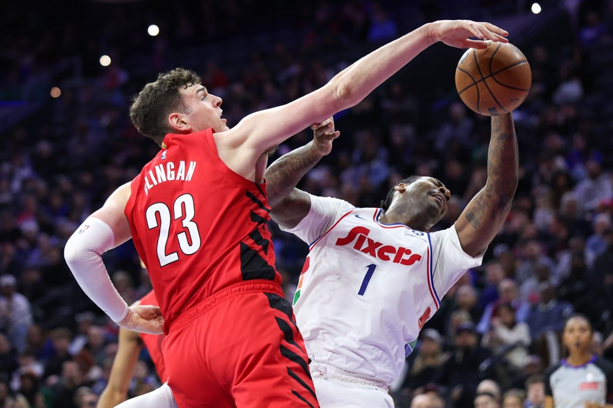 Mar 3, 2025; Philadelphia, Pennsylvania, USA; Portland Trail Blazers center Donovan Clingan (23) blocks the drive of Philadelphia 76ers center Andre Drummond (1) during the second quarter at Wells Fargo Center. Mandatory Credit: Bill Streicher-Imagn Images