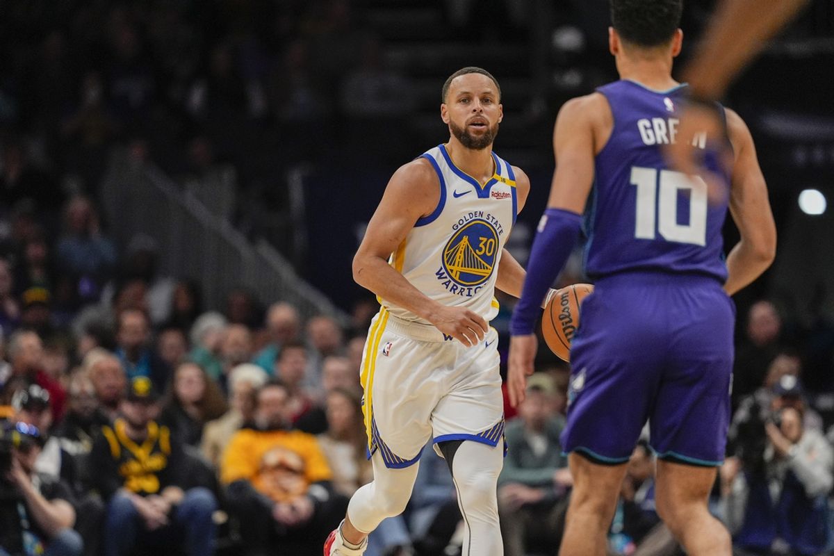 Mar 3, 2025; Charlotte, North Carolina, USA; Golden State Warriors guard Stephen Curry (30) brings the ball up court against Charlotte Hornets guard Josh Green (10) during the second quarter at Spectrum Center. Mandatory Credit: Jim Dedmon-Imagn Images