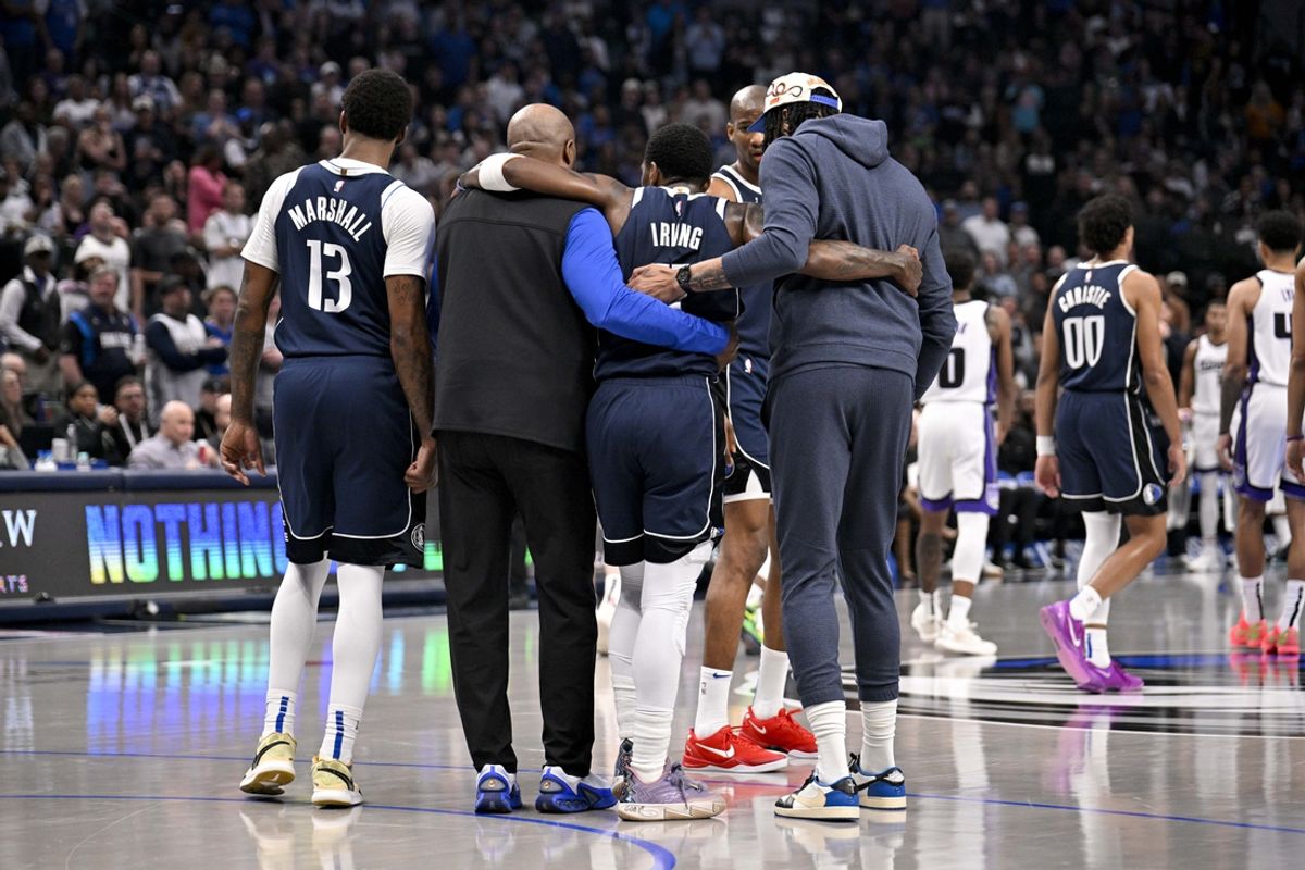 Mar 3, 2025; Dallas, Texas, USA; Dallas Mavericks guard Kyrie Irving (11) is helped off the court by forward Naji Marshall (13) and forward Anthony Davis (3) during the second quarter against the Sacramento Kings at the American Airlines Center. Mandatory Credit: Jerome Miron-Imagn Images