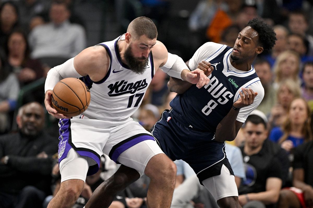 Mar 3, 2025; Dallas, Texas, USA; Sacramento Kings center Jonas Valanciunas (17) looks to move the ball past Dallas Mavericks forward Olivier-Maxence Prosper (8) during the second quarter at the American Airlines Center. Mandatory Credit: Jerome Miron-Imagn Images