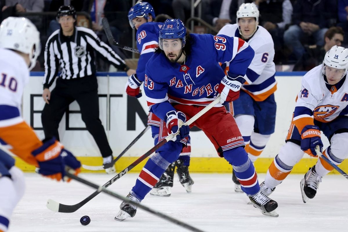 Mar 3, 2025; New York, New York, USA; New York Rangers center Mika Zibanejad (93) skates with the puck against New York Islanders right wing Simon Holmstrom (10) and defenseman Ryan Pulock (6) and center Bo Horvat (14) during the third period at Madison Square Garden. Mandatory Credit: Brad Penner-Imagn Images
