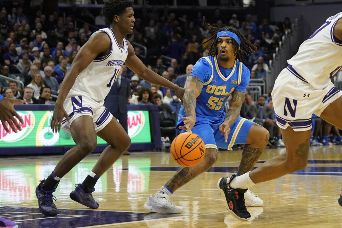 Mar 3, 2025; Evanston, Illinois, USA; Northwestern Wildcats guard Jordan Clayton (11) defends UCLA Bruins guard Skyy Clark (55) during the first half at Welsh-Ryan Arena. Mandatory Credit: David Banks-Imagn Images