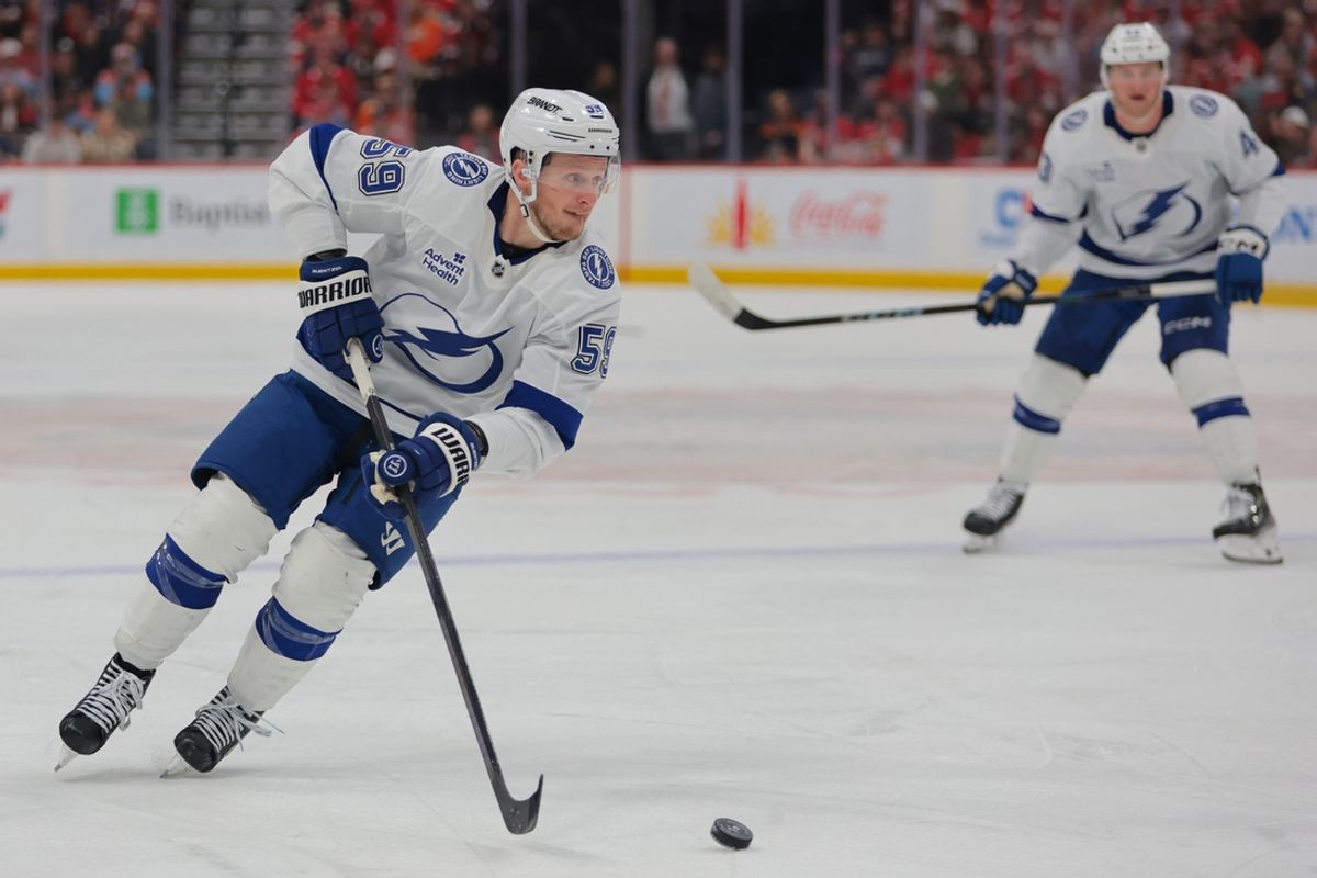 Mar 3, 2025; Sunrise, Florida, USA; Tampa Bay Lightning center Jake Guentzel (59) moves the puck against the Florida Panthers during the third period at Amerant Bank Arena. Mandatory Credit: Sam Navarro-Imagn Images