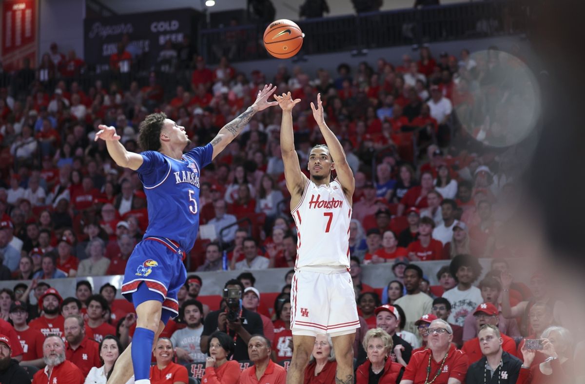 Mar 3, 2025; Houston, Texas, USA; Houston Cougars guard Milos Uzan (7) shoots the ball as Kansas Jayhawks guard Zeke Mayo (5) defends during the second half at Fertitta Center. Mandatory Credit: Troy Taormina-Imagn Images
