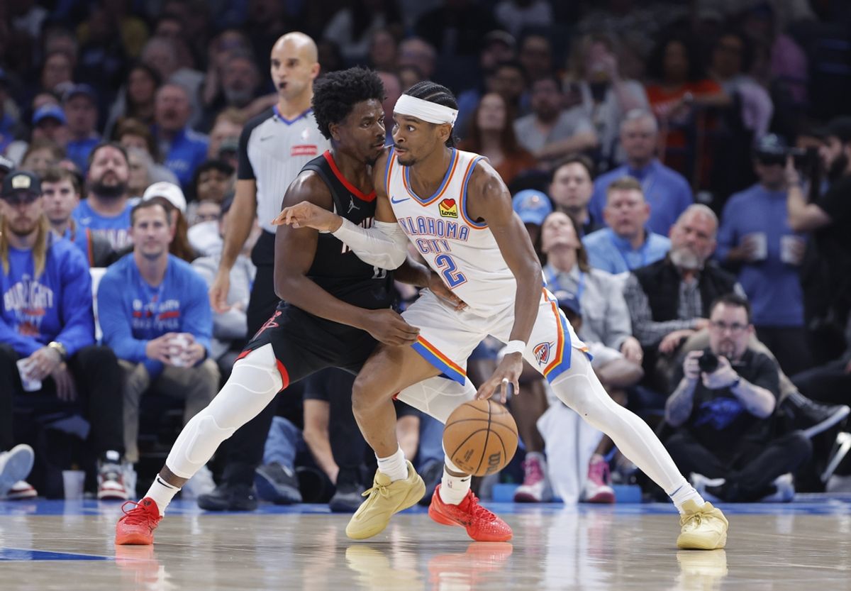 Mar 3, 2025; Oklahoma City, Oklahoma, USA; Oklahoma City Thunder guard Shai Gilgeous-Alexander (2) drives to the baskets against Houston Rockets guard Aaron Holiday (0) during the second half at Paycom Center. Mandatory Credit: Alonzo Adams-Imagn Images