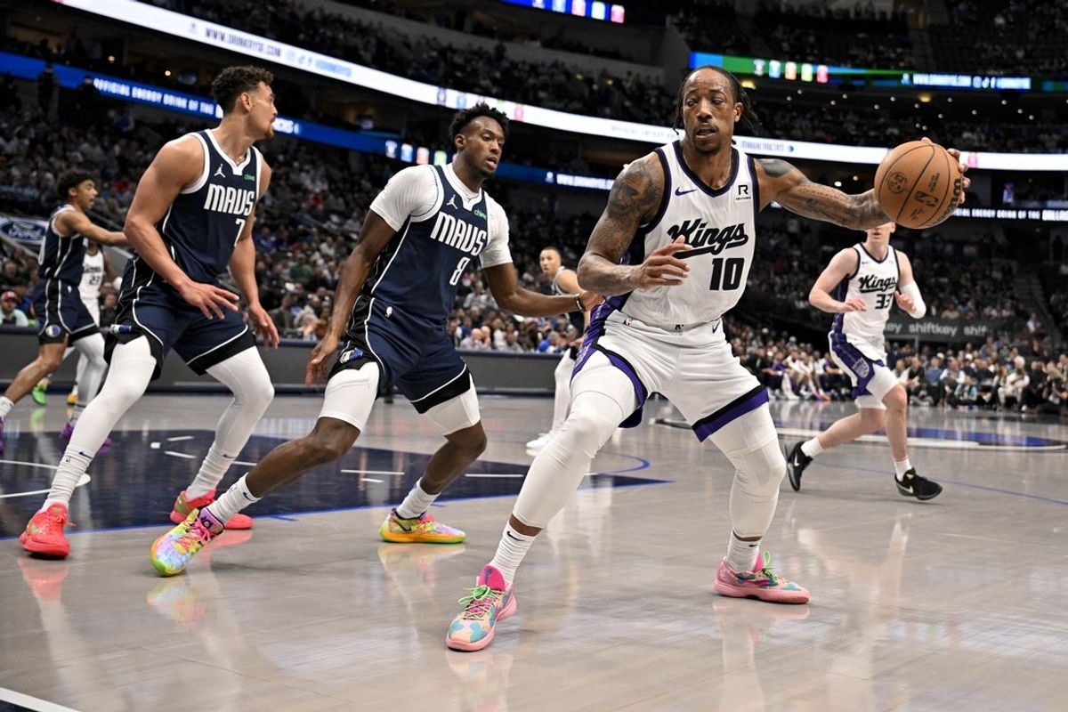 Mar 3, 2025; Dallas, Texas, USA; Sacramento Kings forward DeMar DeRozan (10) controls the ball in front of Dallas Mavericks center Dwight Powell (7) and forward Olivier-Maxence Prosper (8) during the second half at the American Airlines Center. Mandatory Credit: Jerome Miron-Imagn Images