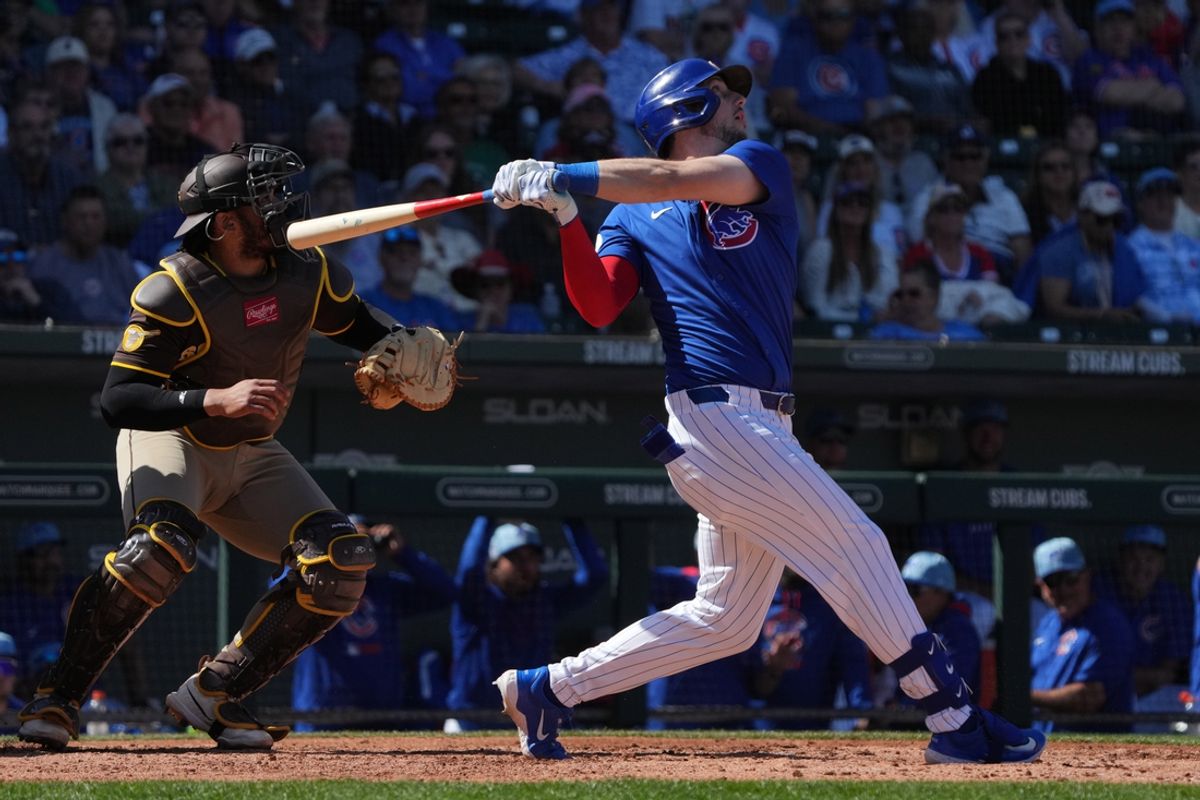 Mar 4, 2025; Mesa, Arizona, USA; Chicago Cubs outfielder Kyle Tucker (30) hits an RBI sacrifice fly out against the San Diego Padres in the third inning at Sloan Park. Mandatory Credit: Rick Scuteri-Imagn Images