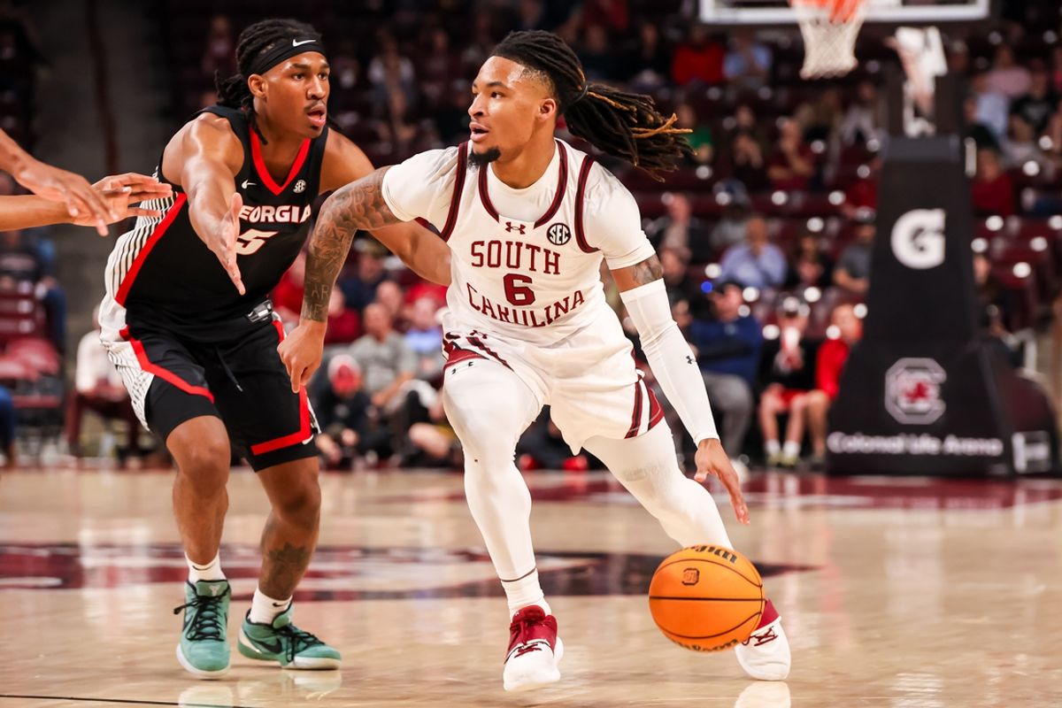 Mar 4, 2025; Columbia, South Carolina, USA; South Carolina Gamecocks guard Jamarii Thomas (6) drives around Georgia Bulldogs guard Silas Demary Jr. (5) in the first half at Colonial Life Arena. Mandatory Credit: Jeff Blake-Imagn Images