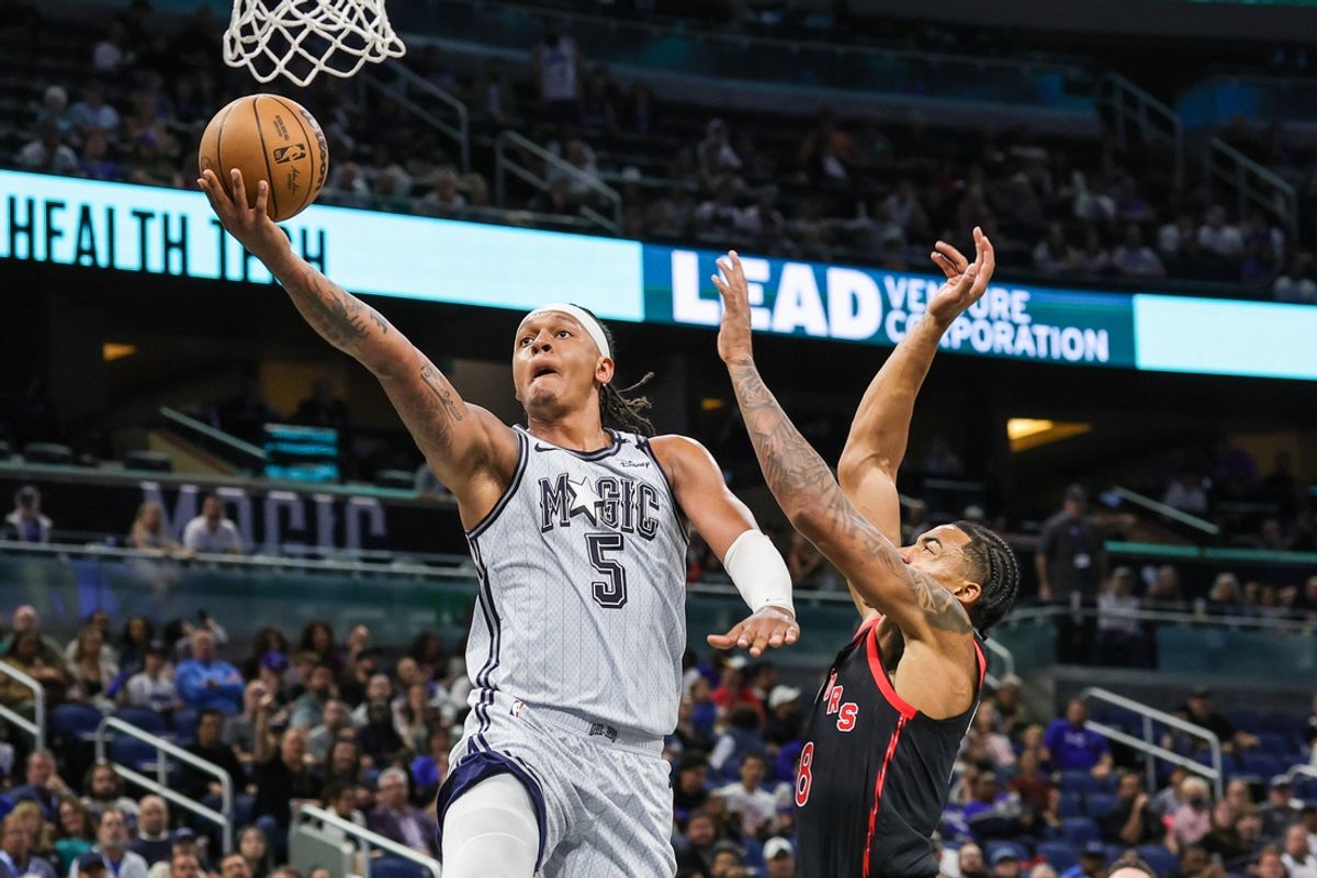 Mar 4, 2025; Orlando, Florida, USA; Orlando Magic forward Paolo Banchero (5) goes to the basket against Toronto Raptors guard Jared Rhoden (8) during the second quarter at Kia Center. Mandatory Credit: Mike Watters-Imagn Images