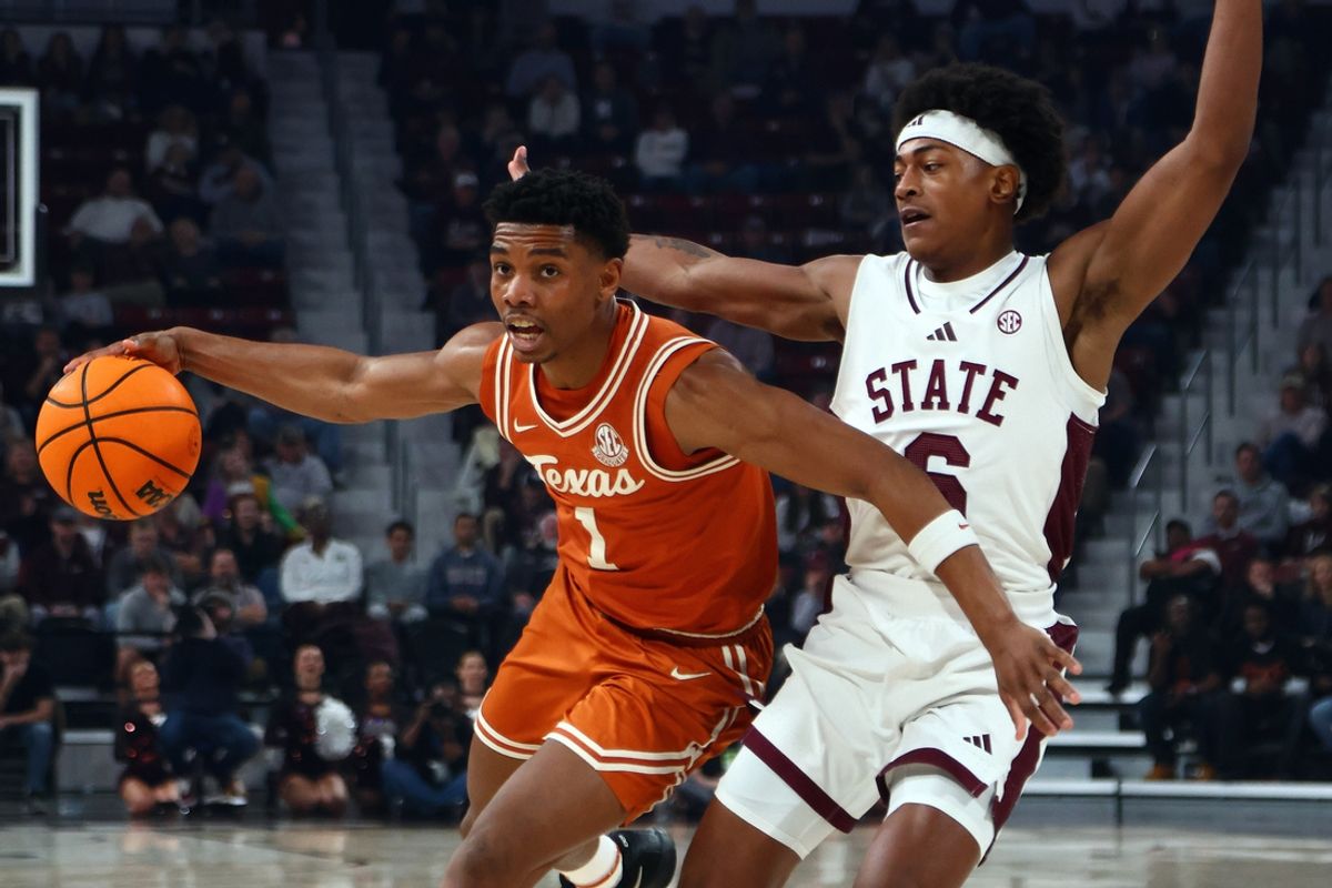 Mar 3, 2025; Memphis, Tennessee, USA; Texas Longhorns guard Julian Larry (1) drives to the basket as Mississippi State Bulldogs guard Dellquan Warren (6) defends during the first half at FedExForum. Mandatory Credit: Petre Thomas-Imagn Images