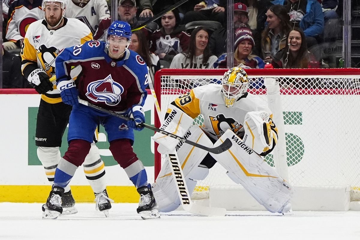 Mar 4, 2025; Denver, Colorado, USA; Colorado Avalanche center Ross Colton (20) and Pittsburgh Penguins goaltender Alex Nedeljkovic (39) in front of the net in the first period at Ball Arena. Mandatory Credit: Ron Chenoy-Imagn Images