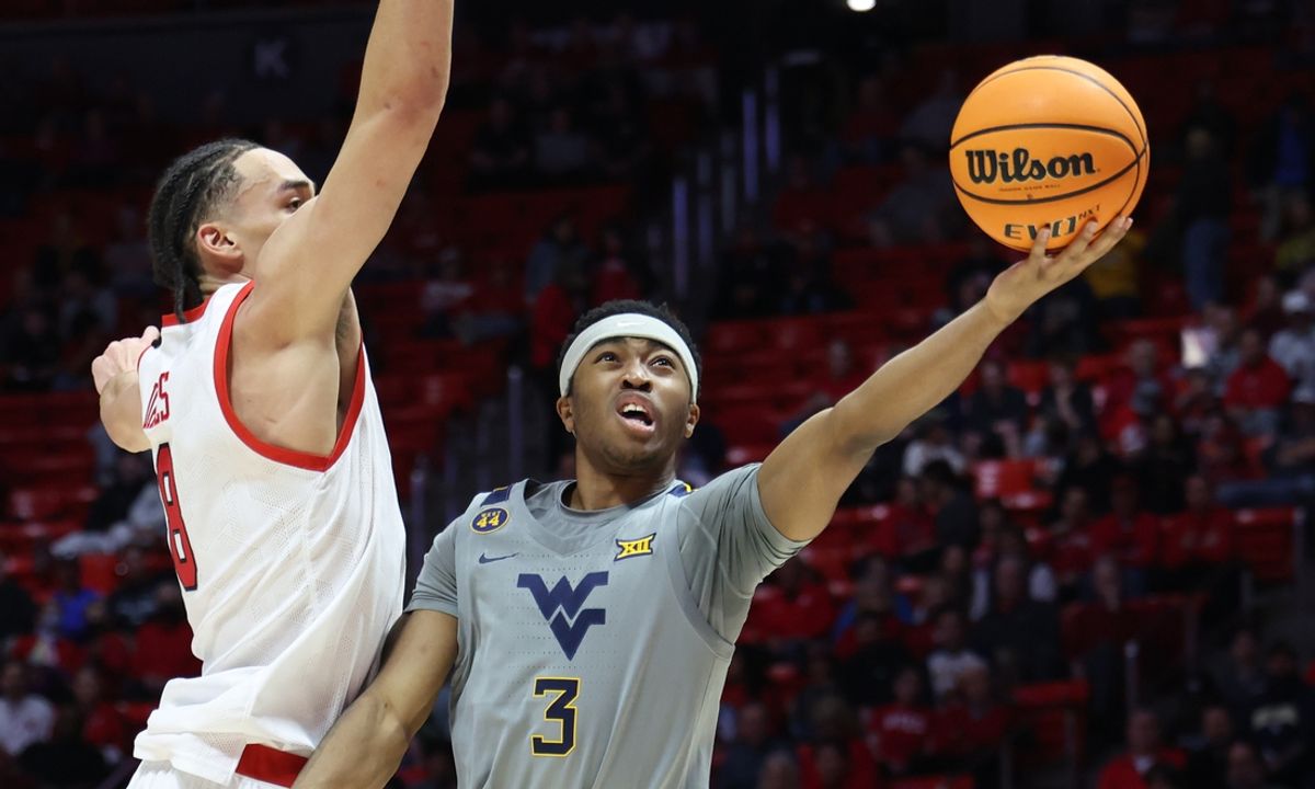 Mar 4, 2025; Salt Lake City, Utah, USA; West Virginia Mountaineers guard KJ Tenner (3) lays the ball up against Utah Utes forward Keanu Dawes (8) during the first half at Jon M. Huntsman Center. Mandatory Credit: Rob Gray-Imagn Images