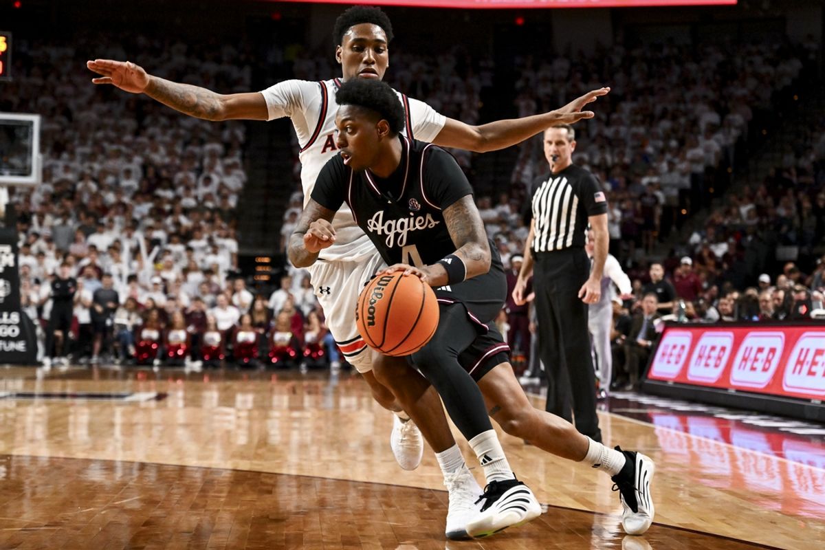 Mar 4, 2025; College Station, Texas, USA; Texas A&M Aggies guard Wade Taylor IV (4) drives against Auburn Tigers guard Tahaad Pettiford (0) during the first half at Reed Arena. Mandatory Credit: Maria Lysaker-Imagn Images