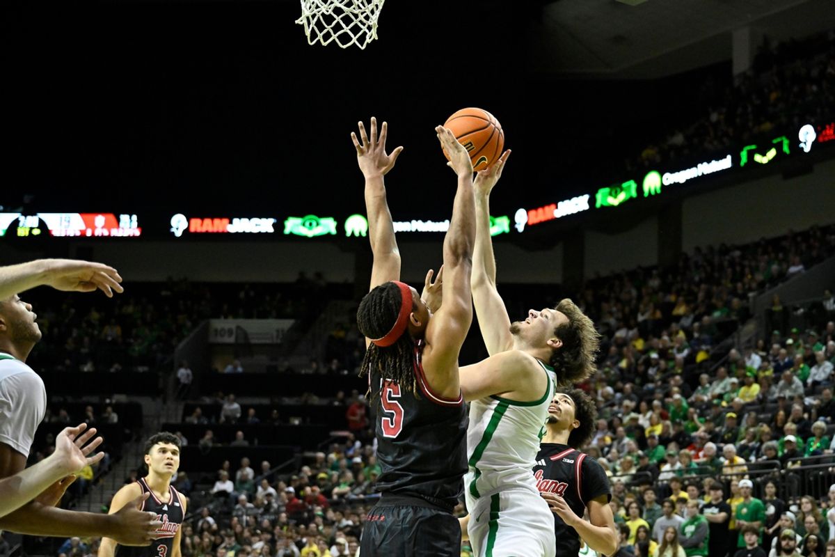 Mar 4, 2025; Eugene, Oregon, USA; Indiana Hoosiers guard Trey Galloway (32) defends a drive to the basket by Oregon Ducks center Nate Bittle (32) during the first half at Matthew Knight Arena. Mandatory Credit: Craig Strobeck-Imagn Images