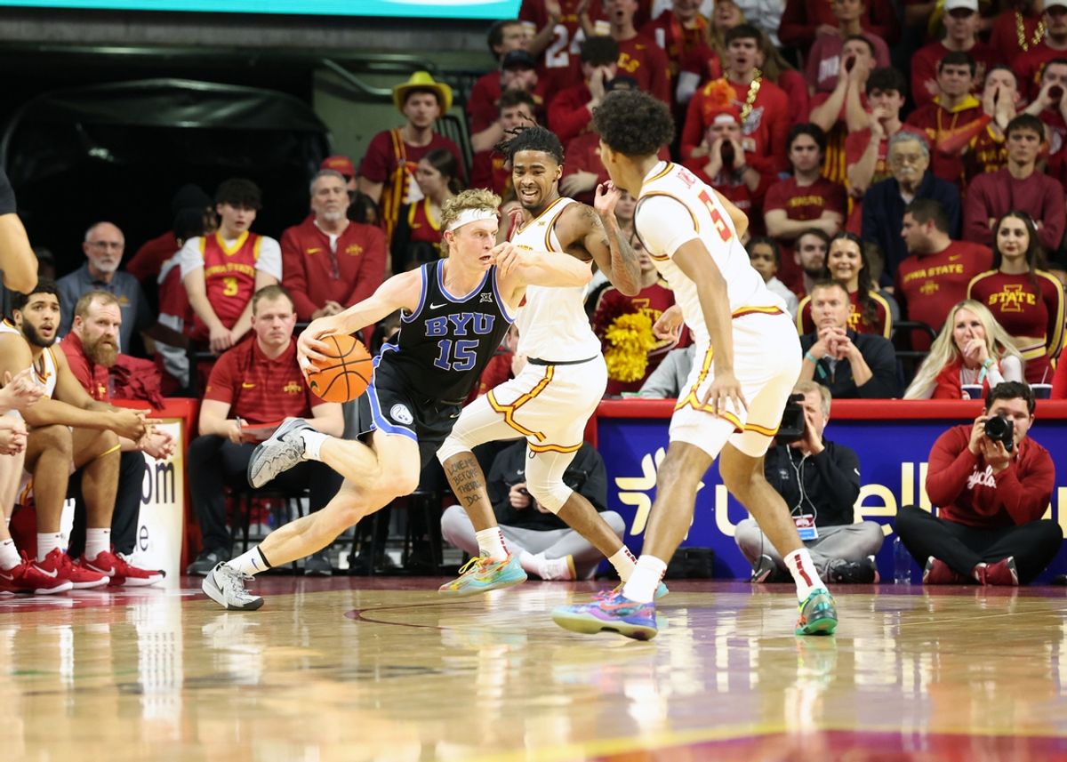 Mar 4, 2025; Ames, Iowa, USA; Iowa State Cyclones guard Keshon Gilbert (10) and Iowa State Cyclones guard Curtis Jones (5) defend Brigham Young Cougars forward Richie Saunders (15) at James H. Hilton Coliseum. Mandatory Credit: Reese Strickland-Imagn Images