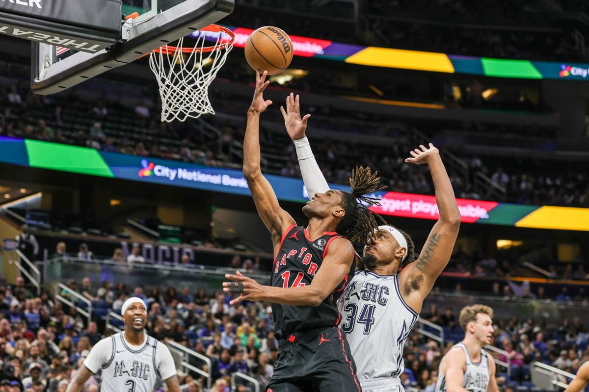 Mar 4, 2025; Orlando, Florida, USA; Toronto Raptors guard Ja'Kobe Walter (14) goes to the basket in front of Orlando Magic center Wendell Carter Jr. (34) during the second half at Kia Center. Mandatory Credit: Mike Watters-Imagn Images