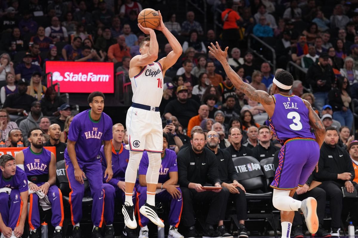 Mar 4, 2025; Phoenix, Arizona, USA; LA Clippers guard Bogdan Bogdanovic (10) shoots against Phoenix Suns guard Bradley Beal (3) during the first half at PHX Center. Mandatory Credit: Joe Camporeale-Imagn Images