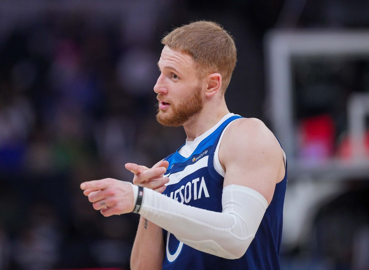 Mar 4, 2025; Minneapolis, Minnesota, USA; Minnesota Timberwolves guard Donte DiVincenzo (0) talks to a referee during a time out against the Philadelphia 76ers in the fourth quarter at Target Center. Mandatory Credit: Brad Rempel-Imagn Images