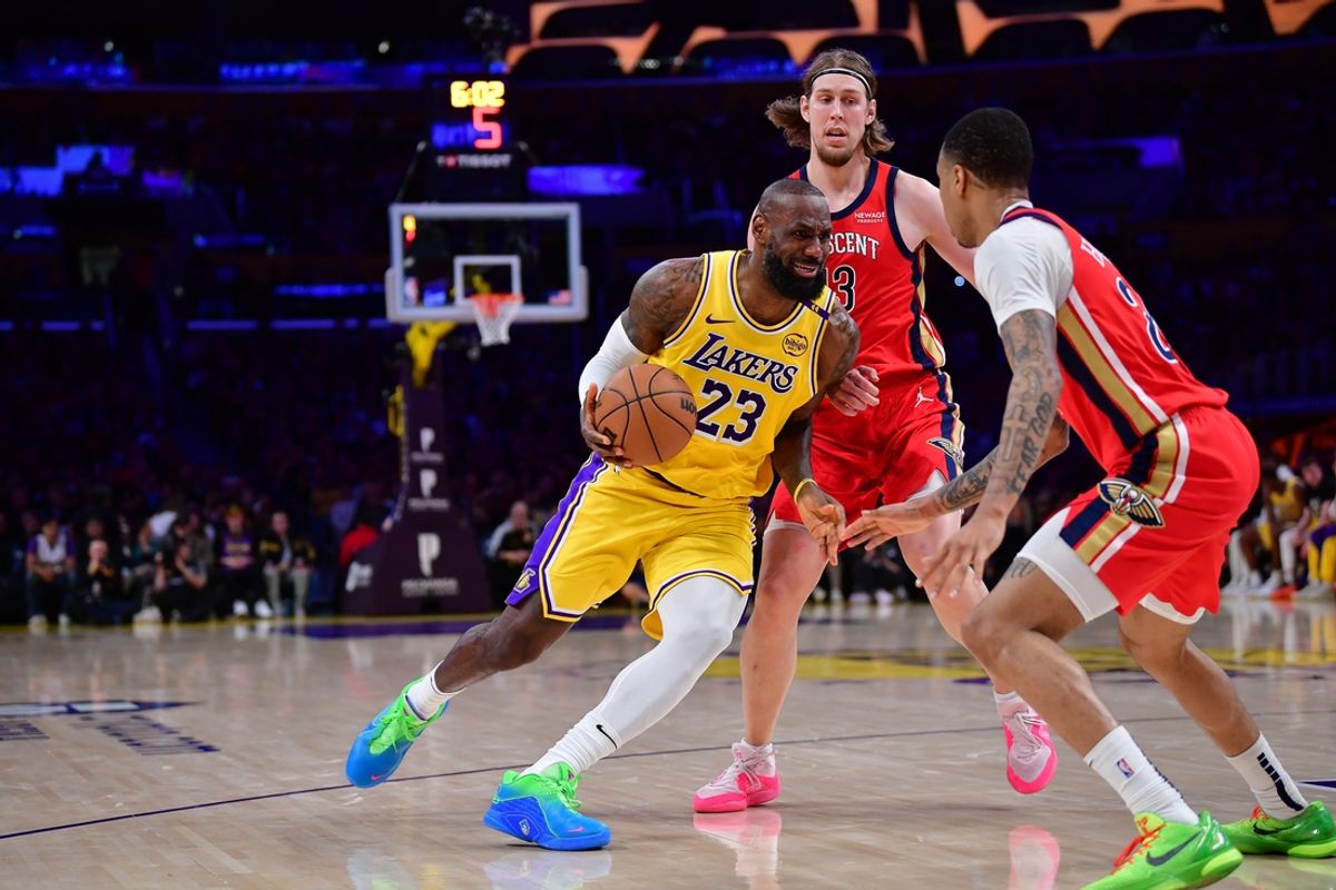Mar 4, 2025; Los Angeles, California, USA; Los Angeles Lakers forward LeBron James (23) moves the ball against New Orleans Pelicans forward Kelly Olynyk (13) and guard Trey Murphy III (25) during the first half at Crypto.com Arena. Mandatory Credit: Gary A. Vasquez-Imagn Images