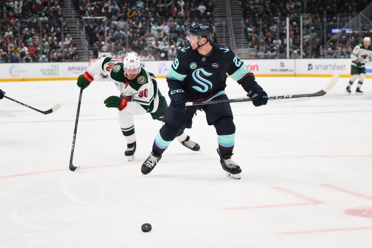 Mar 4, 2025; Seattle, Washington, USA; Minnesota Wild left wing Marcus Johansson (90) and Seattle Kraken defenseman Vince Dunn (29) chase the loose puck during the second period at Climate Pledge Arena. Mandatory Credit: Steven Bisig-Imagn Images